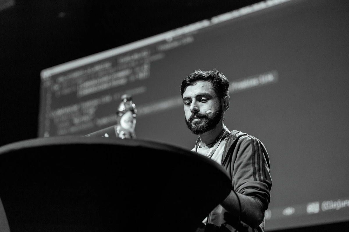 Mitesh on stage at Heart of Clojure